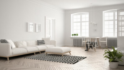 Bright minimalist living room with sofa and dining table, scandinavian white interior design